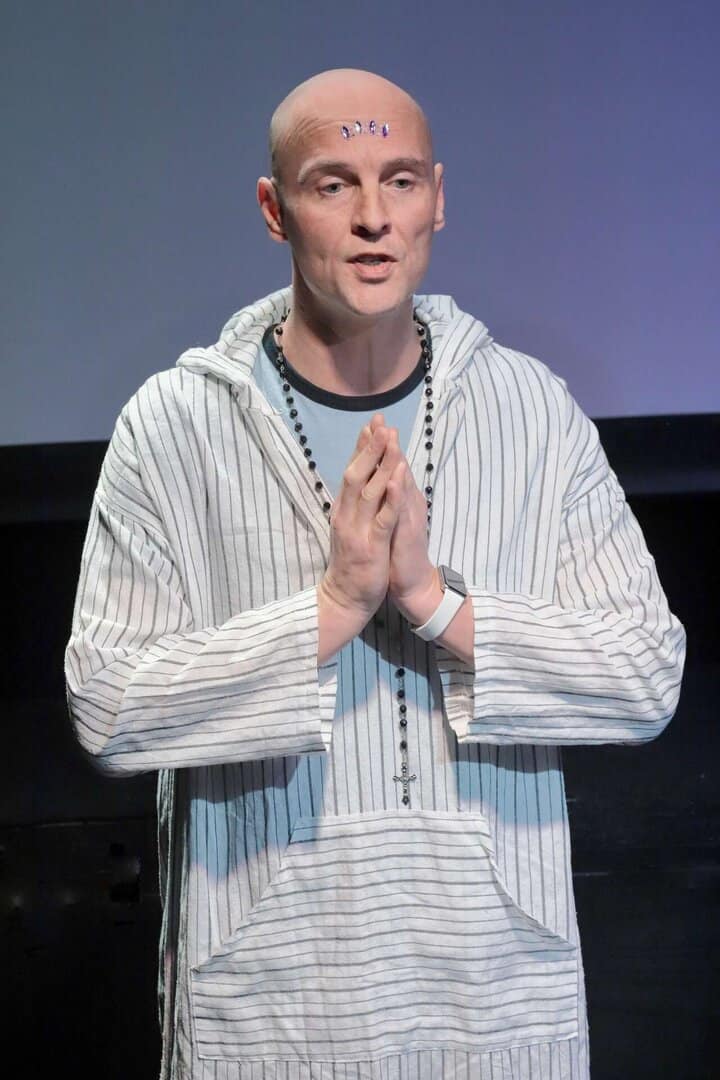 Supportive man praying at a recovery event, promoting hope and healing for addiction recovery.