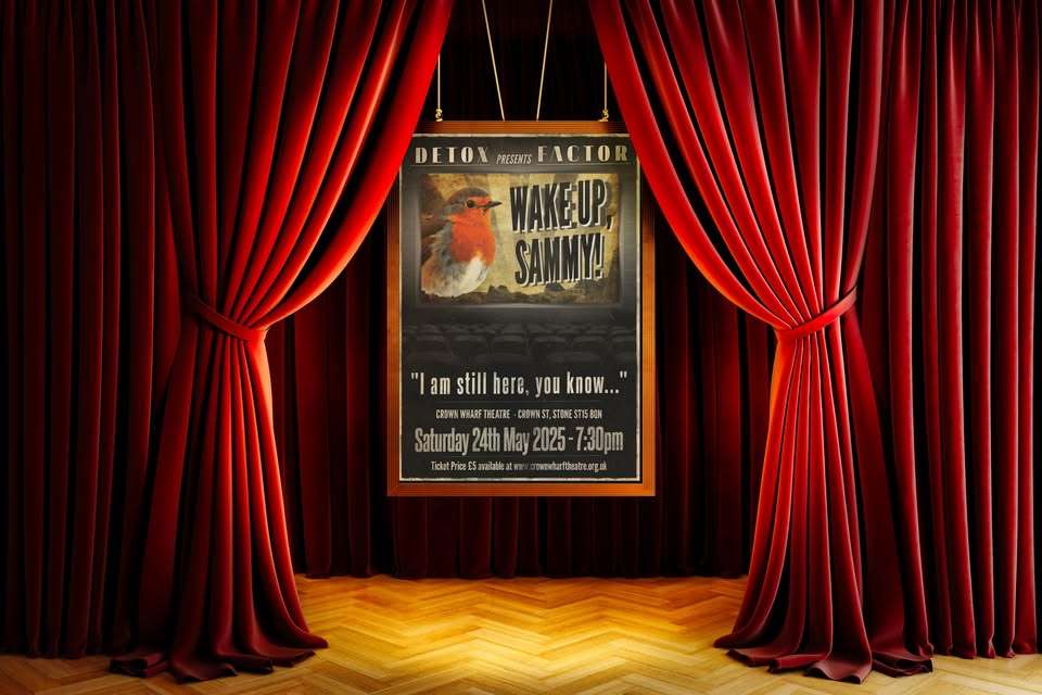 Theatre stage with "Wake Up Sammy" poster and red curtains.